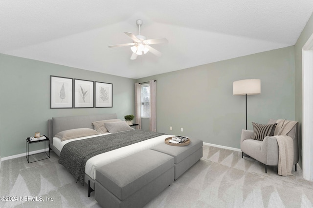 carpeted bedroom featuring vaulted ceiling, a textured ceiling, and ceiling fan