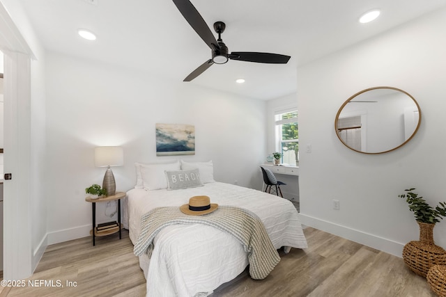 bedroom with ceiling fan and light hardwood / wood-style floors