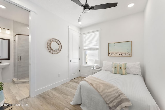 bedroom with light hardwood / wood-style floors, ensuite bath, and ceiling fan