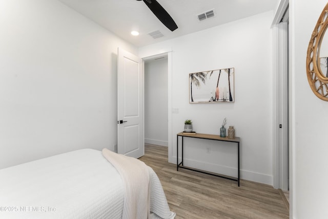 bedroom with light hardwood / wood-style flooring and ceiling fan