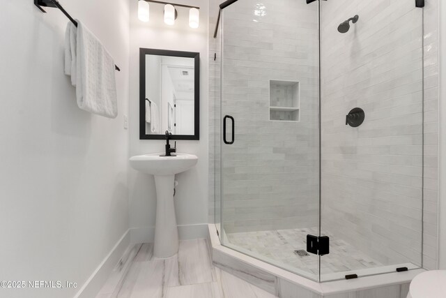 bathroom featuring a shower with door