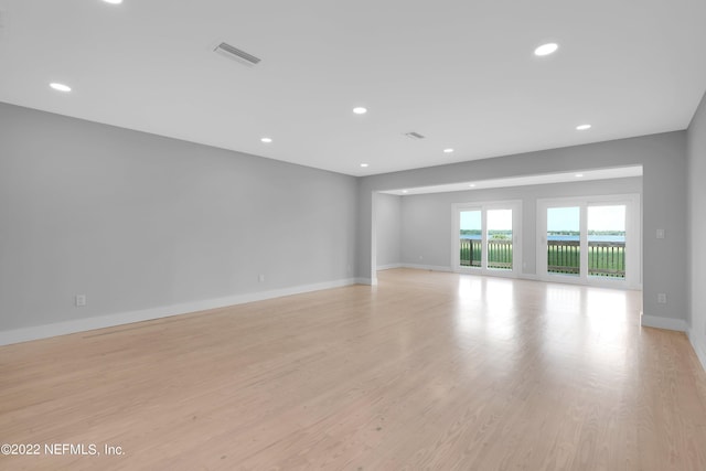 empty room with light hardwood / wood-style flooring