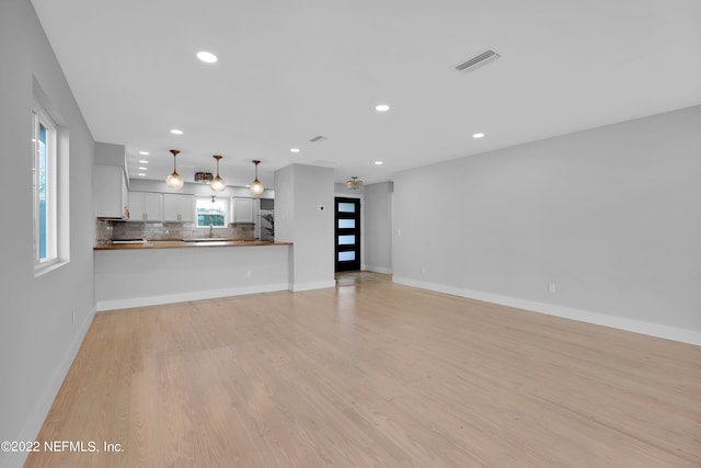 unfurnished living room with light hardwood / wood-style flooring