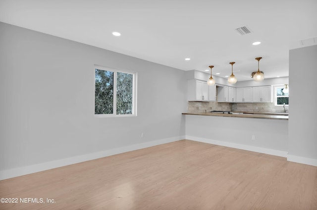 unfurnished living room with light hardwood / wood-style flooring