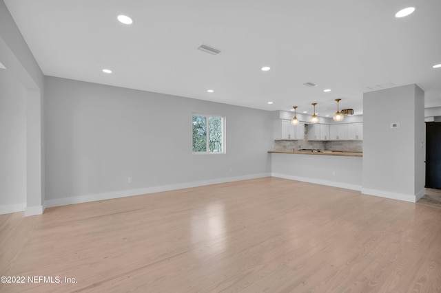 unfurnished living room with light hardwood / wood-style floors