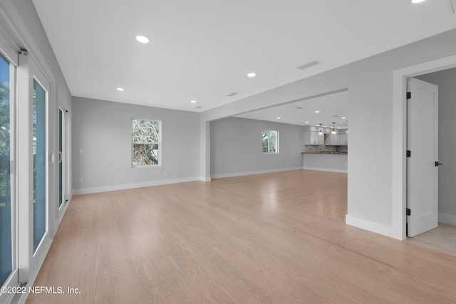 unfurnished living room with light hardwood / wood-style flooring