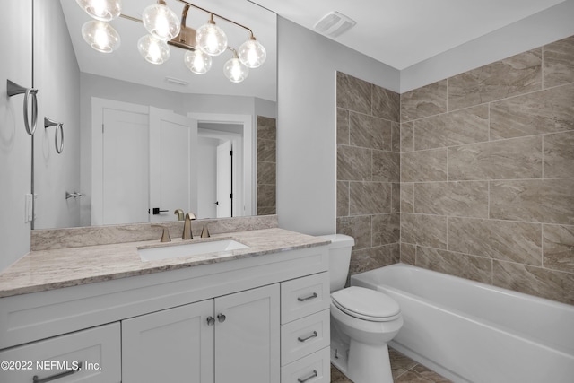 full bathroom featuring toilet, vanity, and tiled shower / bath