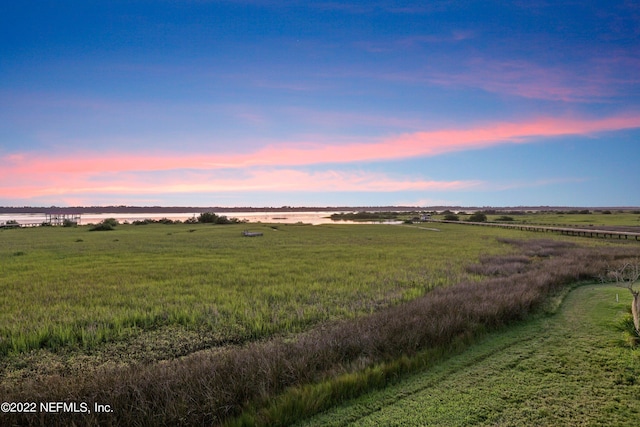 nature at dusk featuring a water view and a rural view