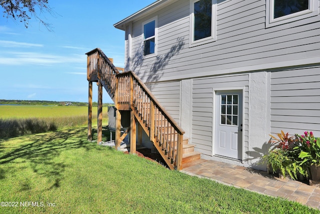 view of exterior entry with a lawn