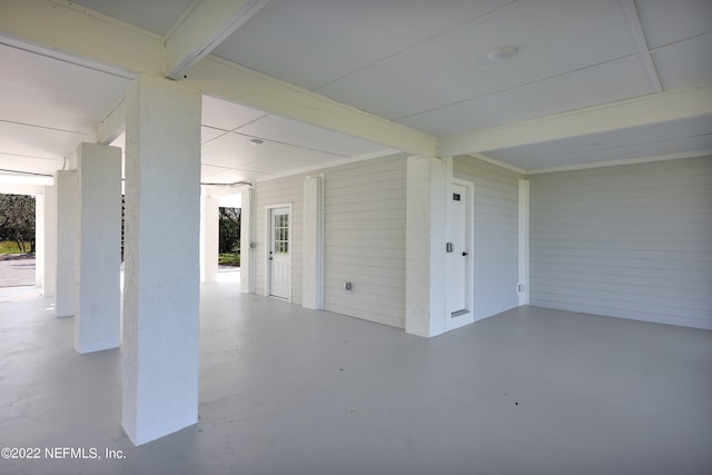 basement featuring wooden walls