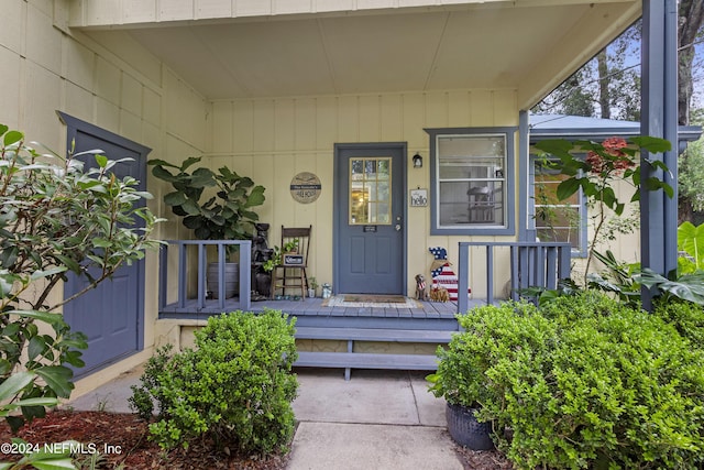 view of exterior entry featuring a porch