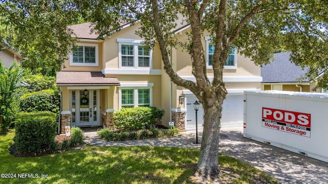 view of front of property with a garage and french doors