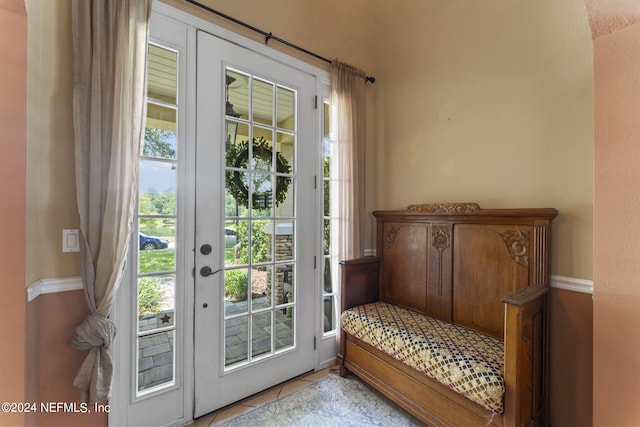 doorway featuring a healthy amount of sunlight and light tile patterned floors