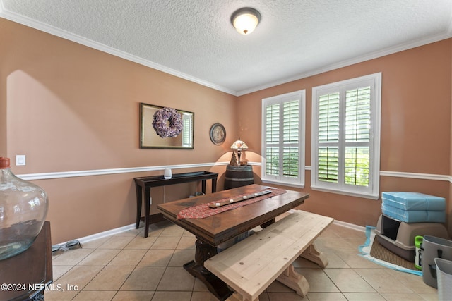 dining space featuring ornamental molding, a wealth of natural light, and a textured ceiling