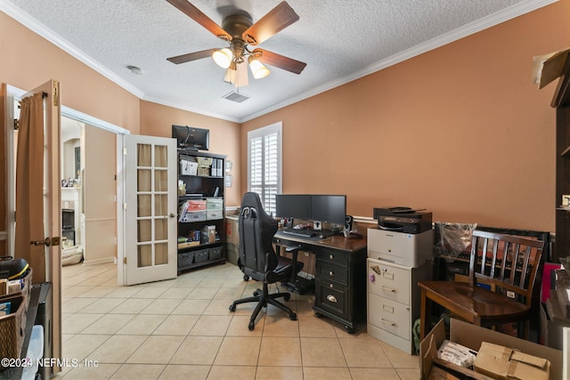 tiled office space with crown molding, a textured ceiling, ceiling fan, and french doors