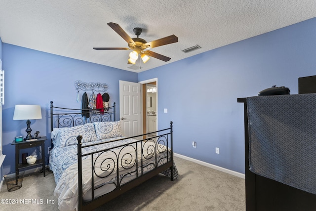 bedroom featuring carpet flooring, a textured ceiling, and ceiling fan