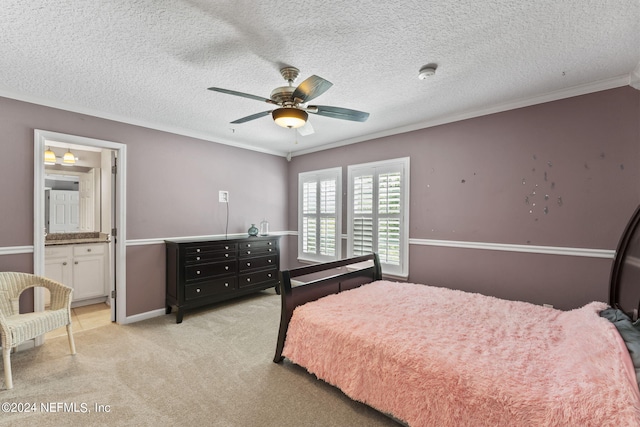 carpeted bedroom featuring ensuite bath, a textured ceiling, ceiling fan, and crown molding