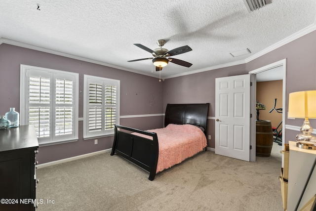 carpeted bedroom with a textured ceiling, ornamental molding, and ceiling fan