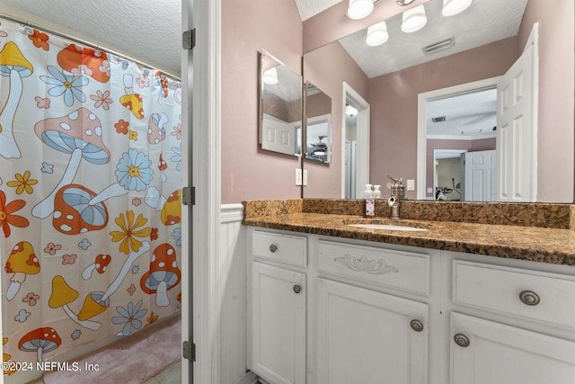 bathroom with vanity and a textured ceiling