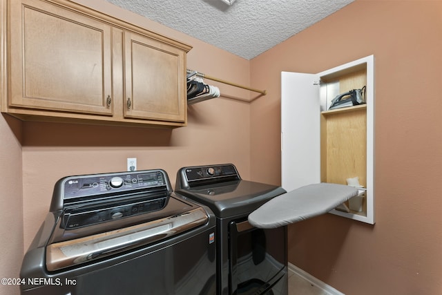 laundry area with separate washer and dryer, cabinets, and a textured ceiling