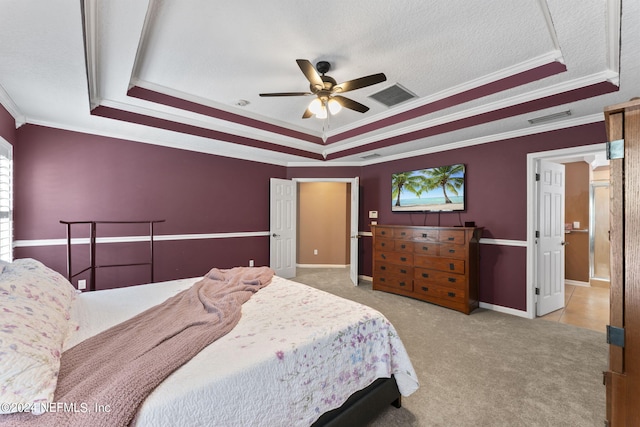 bedroom with a raised ceiling, crown molding, and ceiling fan