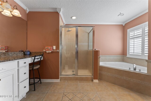 bathroom with shower with separate bathtub, a textured ceiling, tile patterned floors, vanity, and ornamental molding