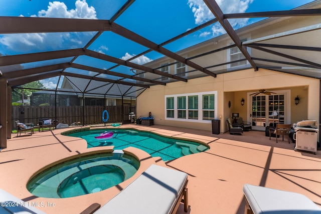 view of pool with a patio, an in ground hot tub, a lanai, and ceiling fan