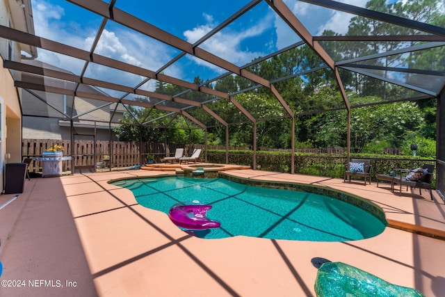 view of swimming pool with an in ground hot tub, a patio, and a lanai