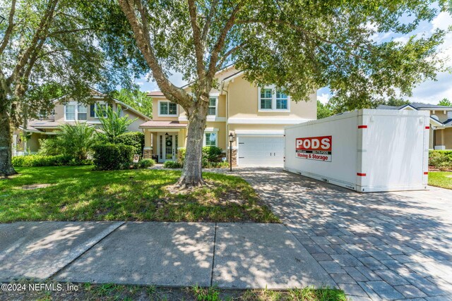 view of front of house featuring a garage and a front yard