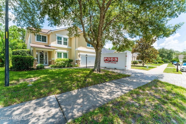 view of front of house featuring a garage and a front yard