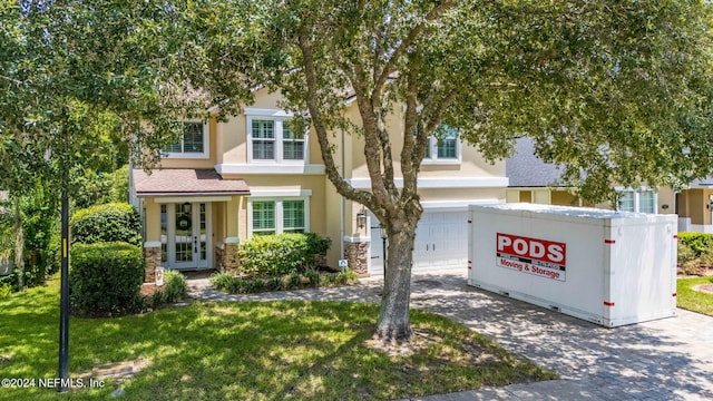 view of front of property with a garage and a front yard