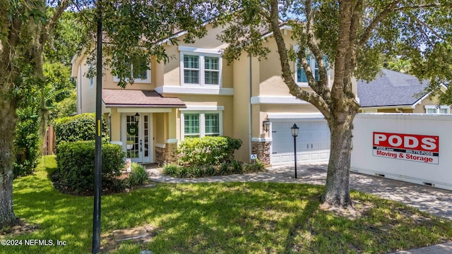 view of front of house featuring a garage and a front lawn