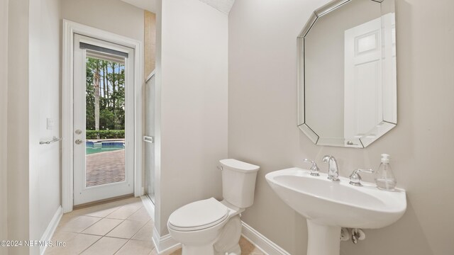 bathroom with tile patterned flooring, toilet, and sink