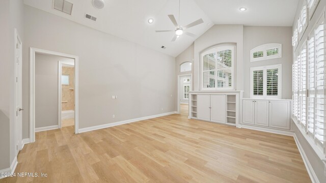 unfurnished living room with high vaulted ceiling, light hardwood / wood-style flooring, and ceiling fan