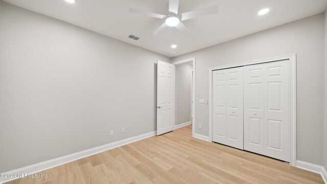 unfurnished bedroom with a closet, ceiling fan, and light hardwood / wood-style floors