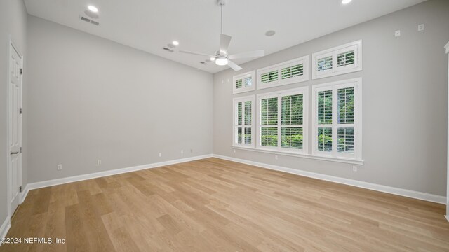 spare room featuring light hardwood / wood-style flooring and ceiling fan