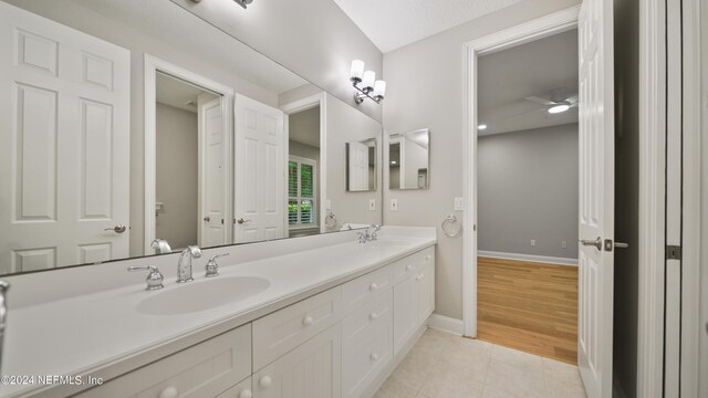 bathroom with tile patterned flooring, vanity, and ceiling fan