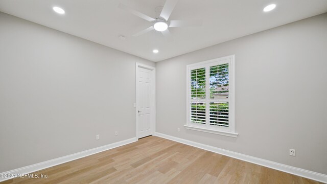 empty room featuring ceiling fan and light hardwood / wood-style flooring