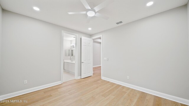 unfurnished room with light wood-type flooring and ceiling fan