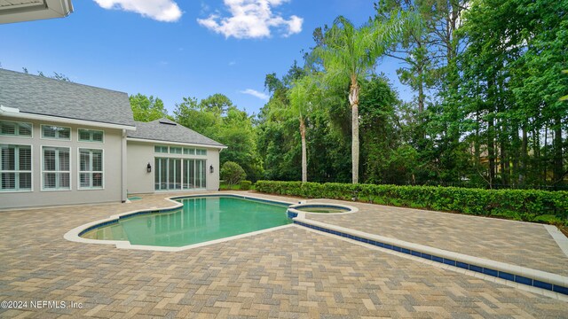 view of pool featuring an in ground hot tub and a patio