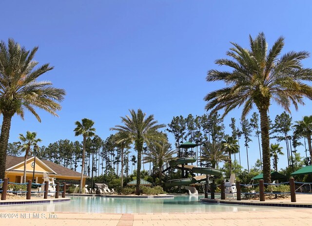 view of swimming pool with a water slide