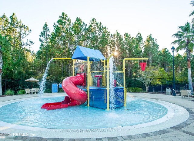 view of jungle gym with pool water feature