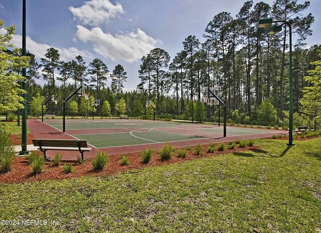 view of basketball court featuring a yard