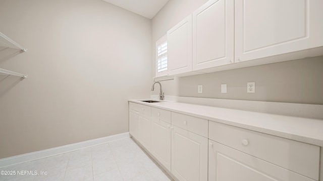 clothes washing area with sink