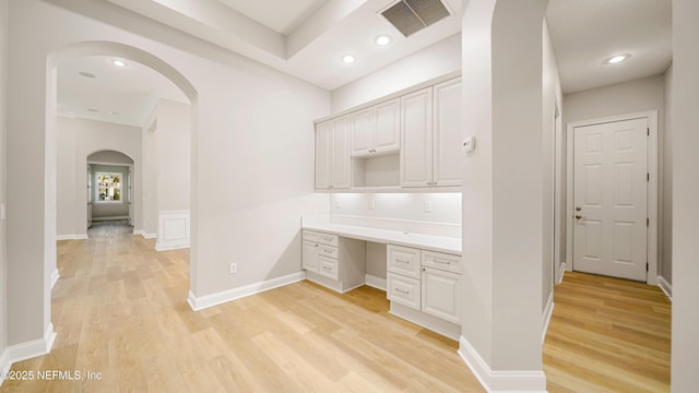 interior space featuring light wood-type flooring and built in desk