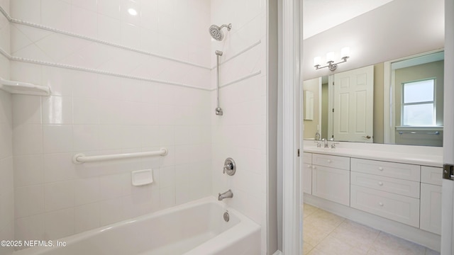 bathroom featuring vanity and tiled shower / bath