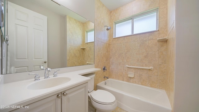 full bathroom featuring vanity, tiled shower / bath combo, and toilet