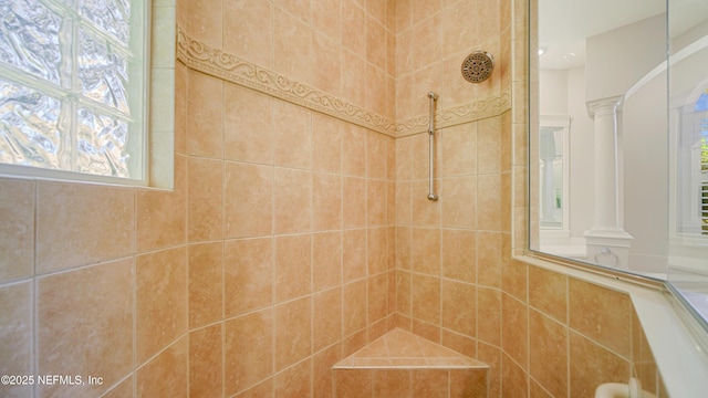 interior details featuring decorative columns and tiled shower