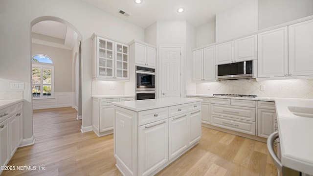 kitchen with a kitchen island, white cabinetry, and stainless steel appliances