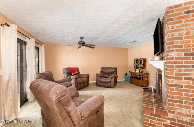 living room featuring a fireplace, carpet, a textured ceiling, brick wall, and ceiling fan